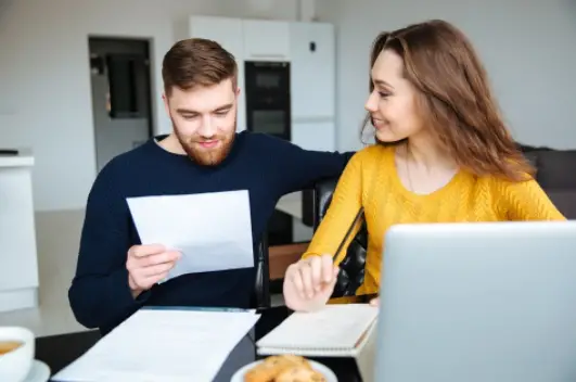 couple looking happy after tax resolution was a success